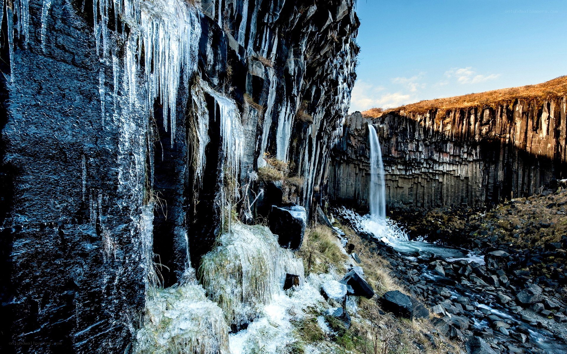 Icy waterfall in basalt canyon