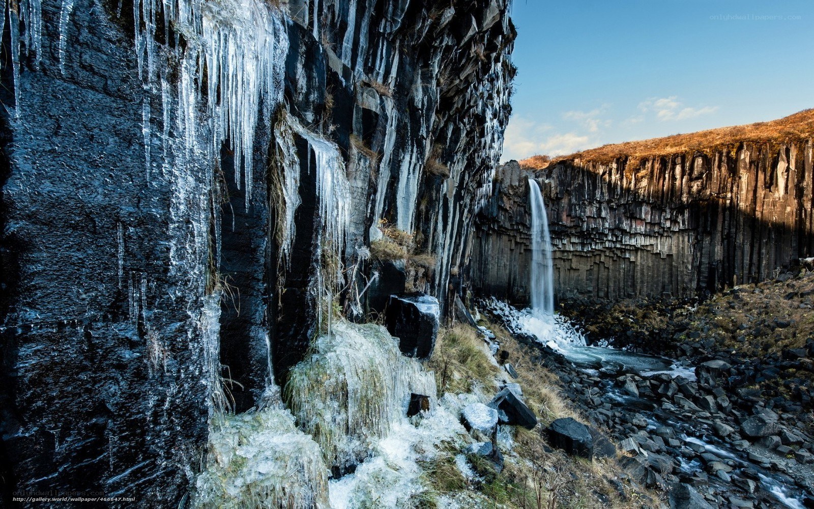 Icy waterfall in basalt canyon