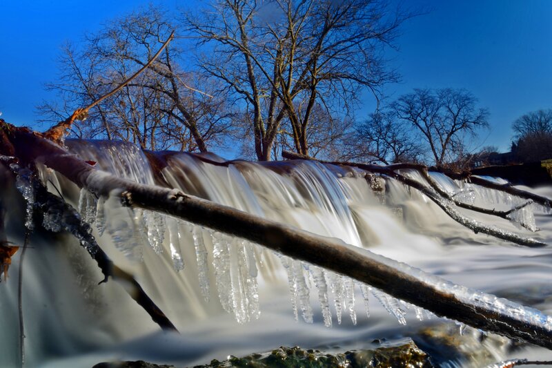 Icy Waterfall with Branches