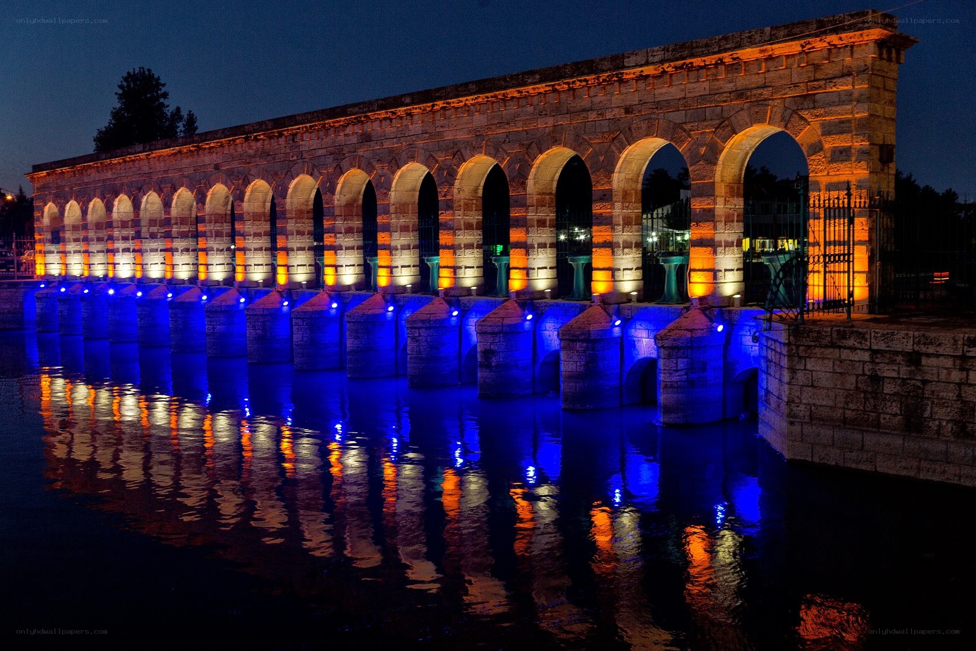 illuminated aqueduct at night