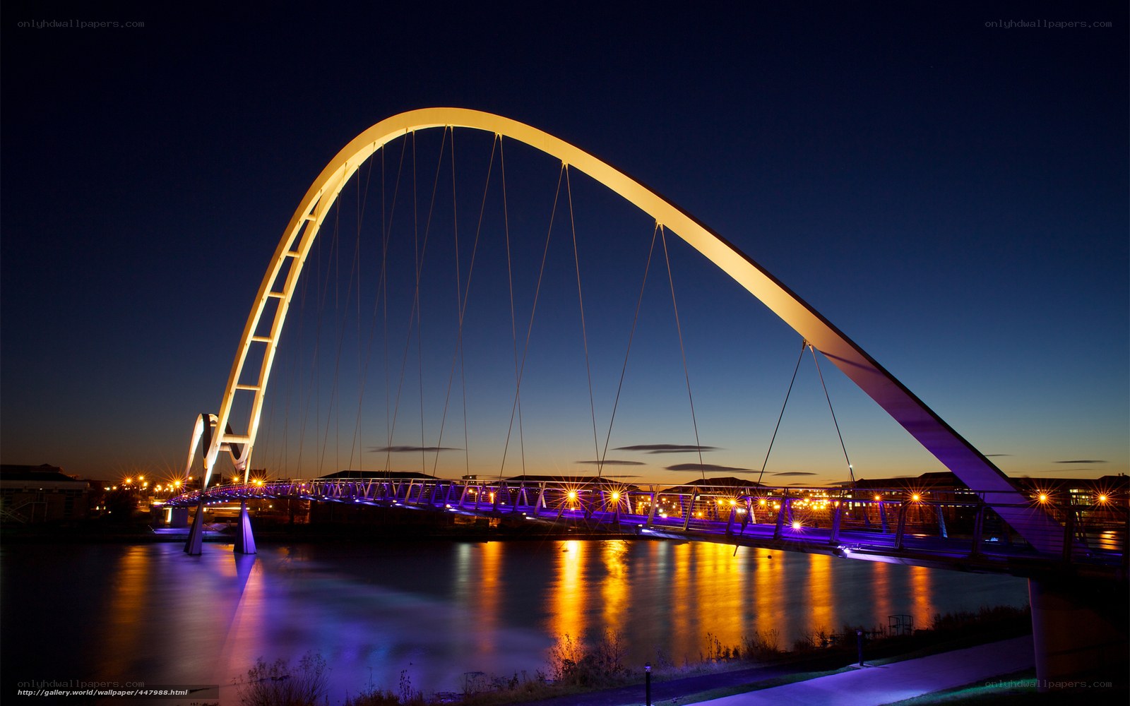 illuminated arch bridge at dusk