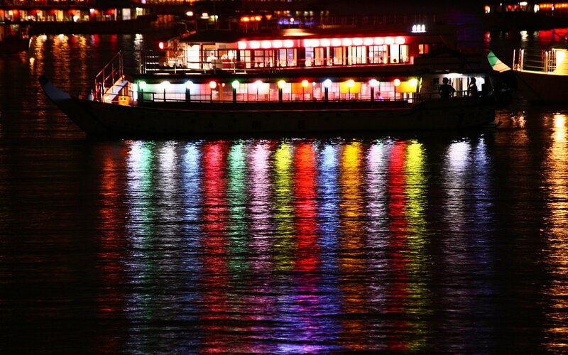 Illuminated Boat on Water — Red