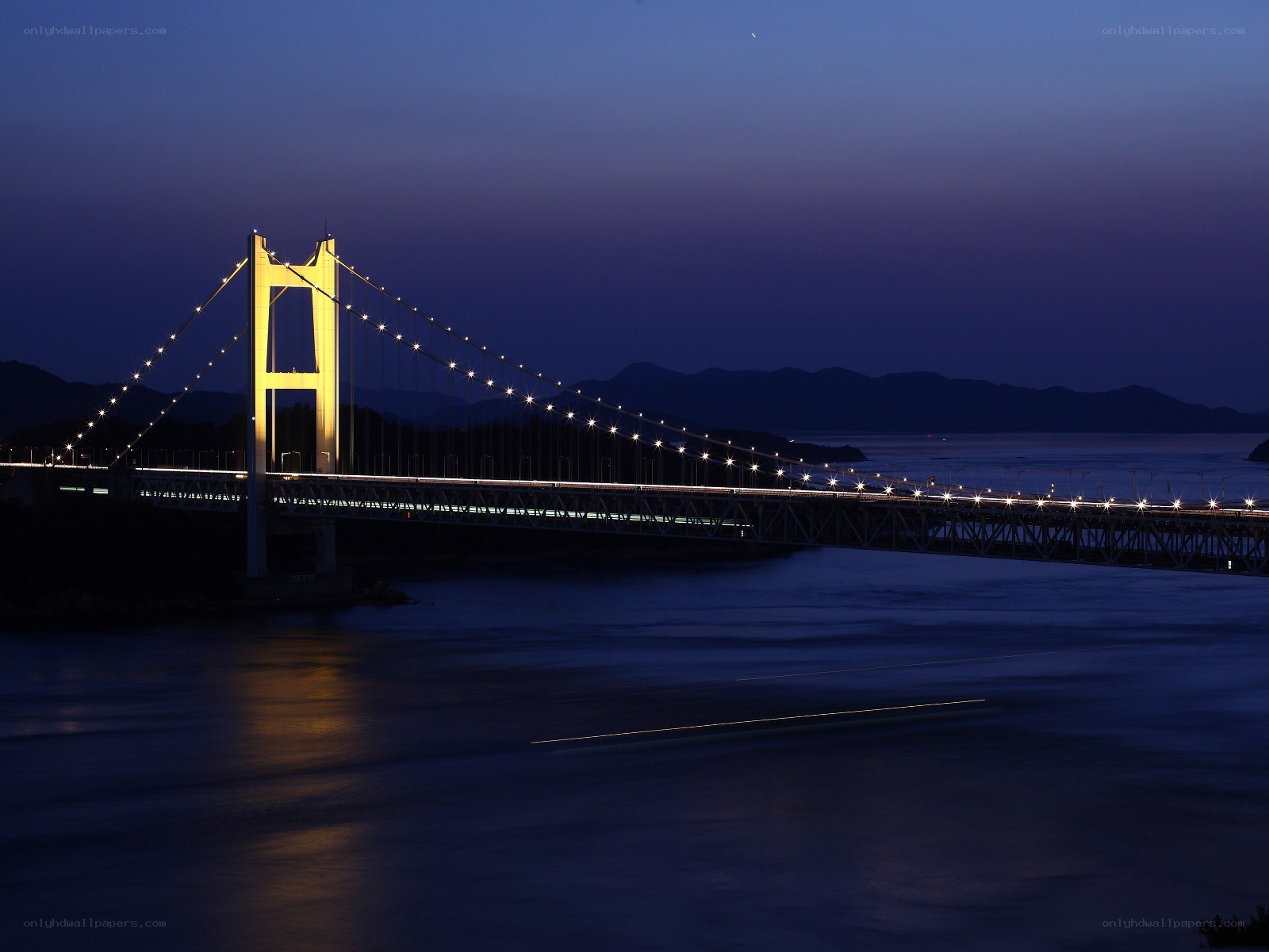 illuminated bridge at dusk
