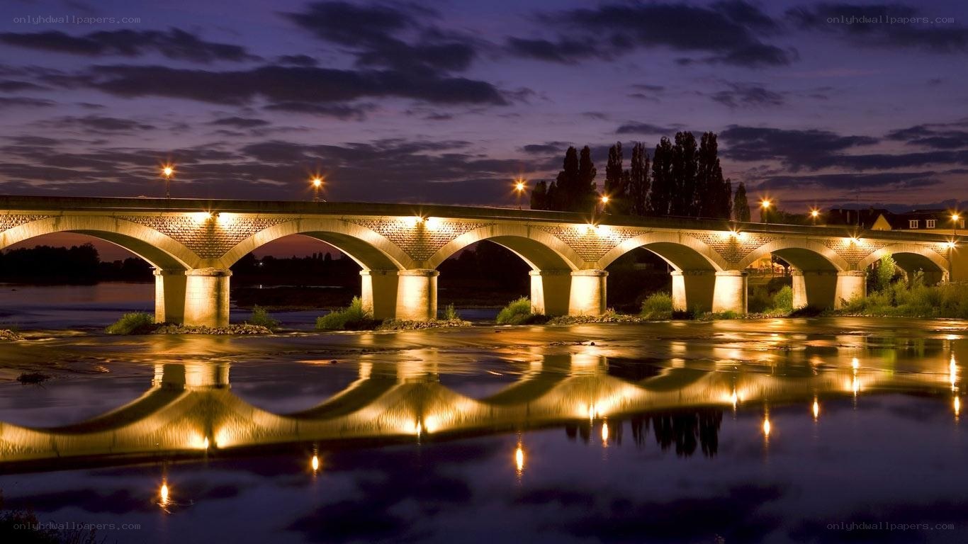 Illuminated bridge at dusk