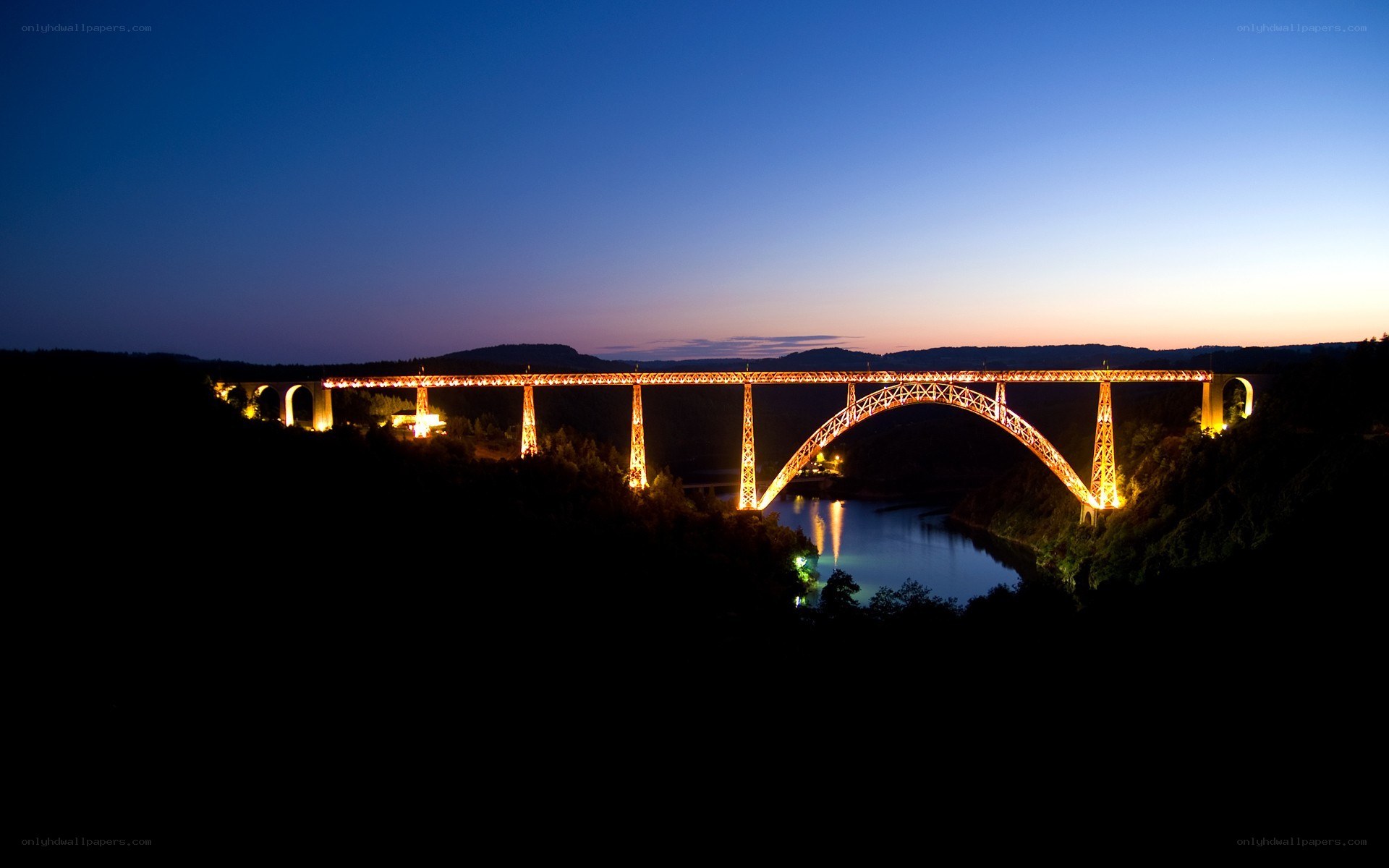 illuminated bridge at dusk