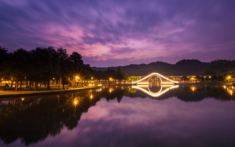 Illuminated Bridge at Dusk — Purple, Serene