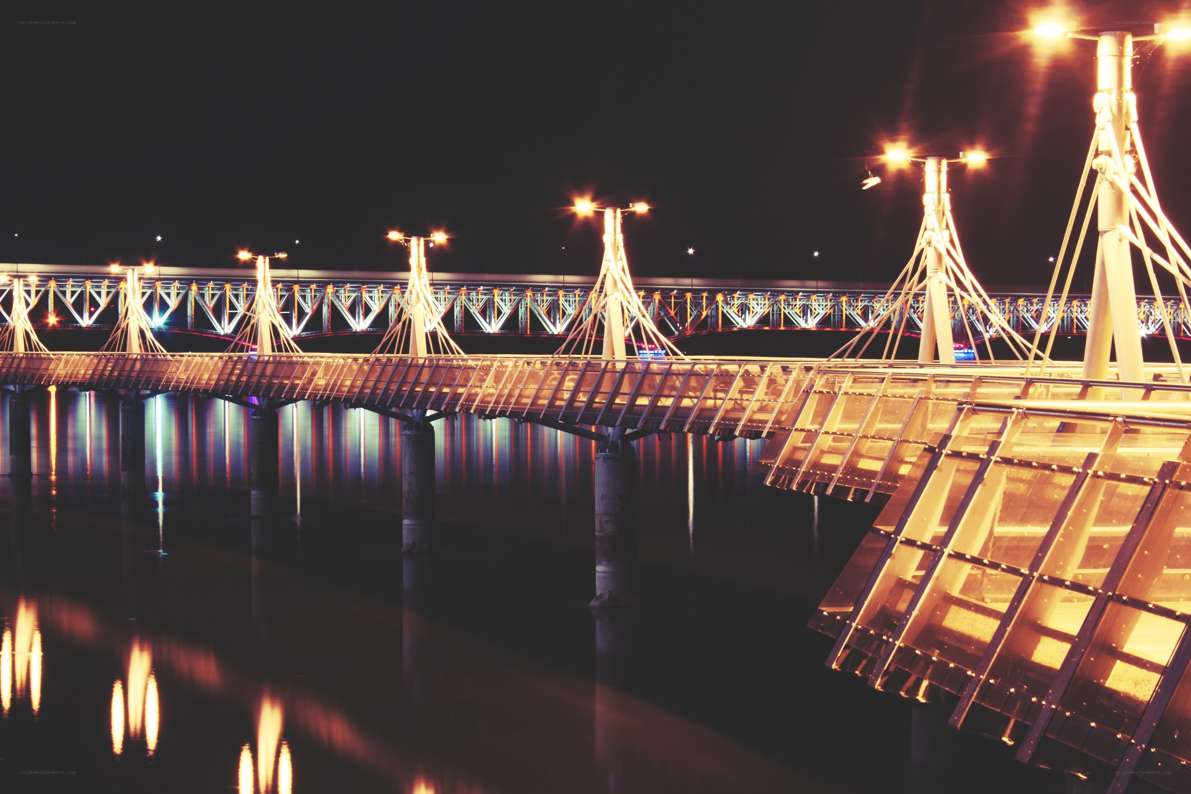 Illuminated bridge at night