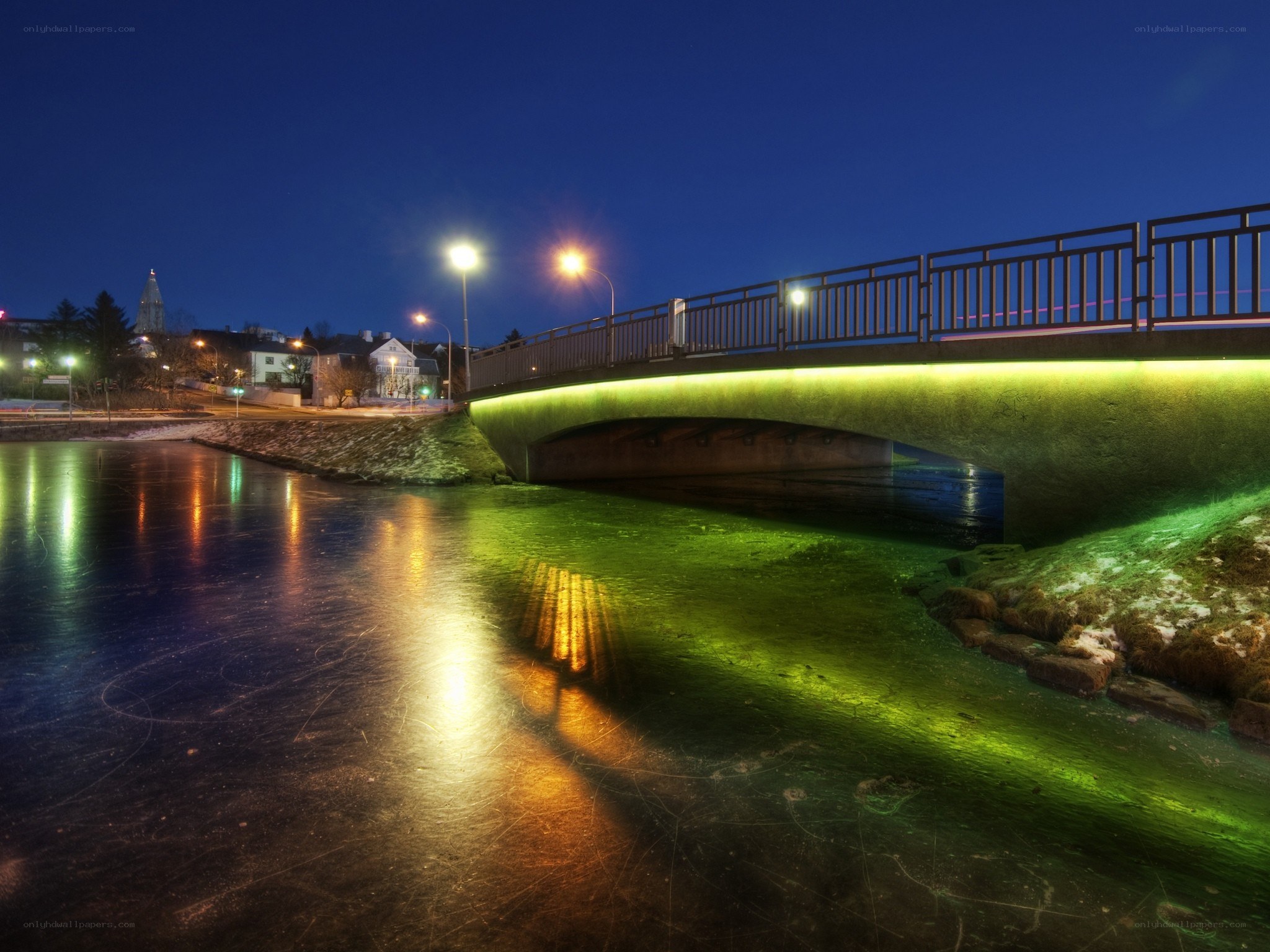 Illuminated bridge at night