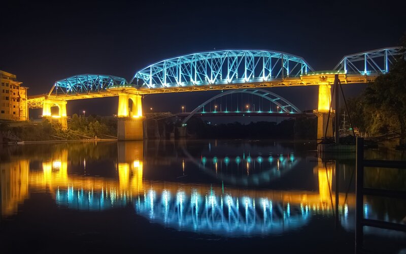 Illuminated bridge at night