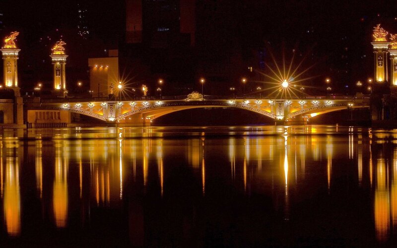 Illuminated Bridge at Night — Yellow, Serene, Photograph, River