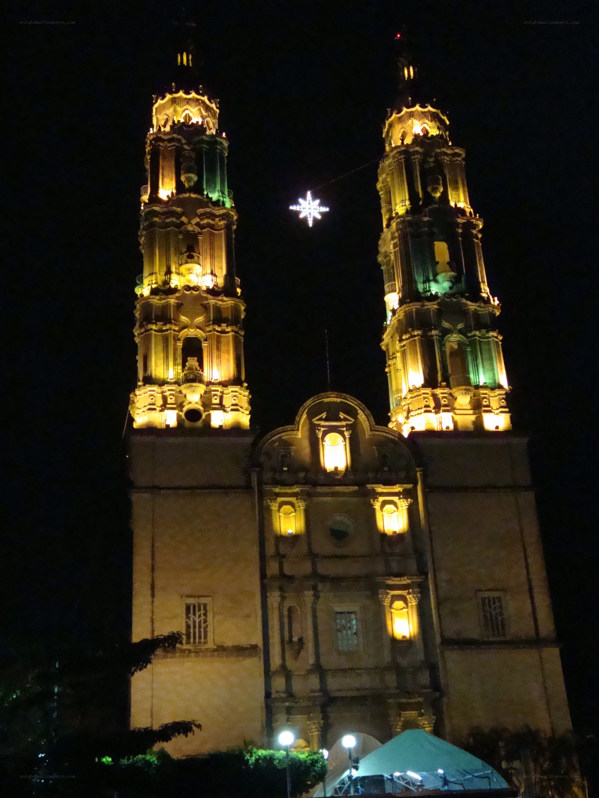 illuminated cathedral towers at night