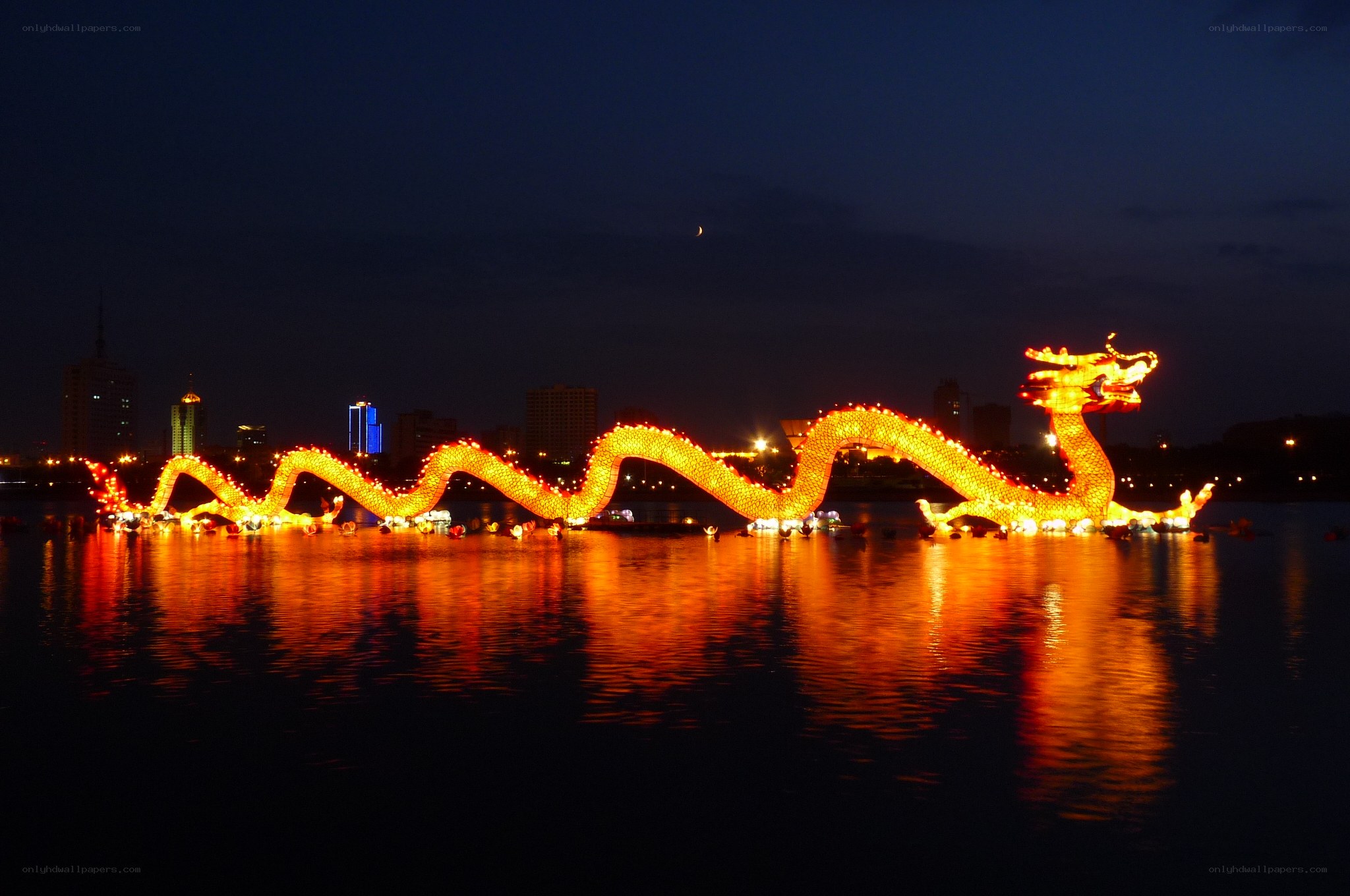 Illuminated dragon boat on water