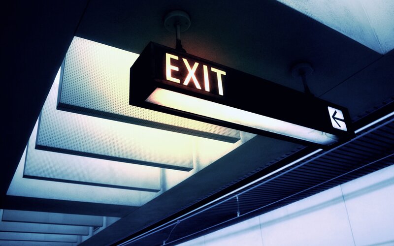 Illuminated Exit Sign — Black, Dramatic