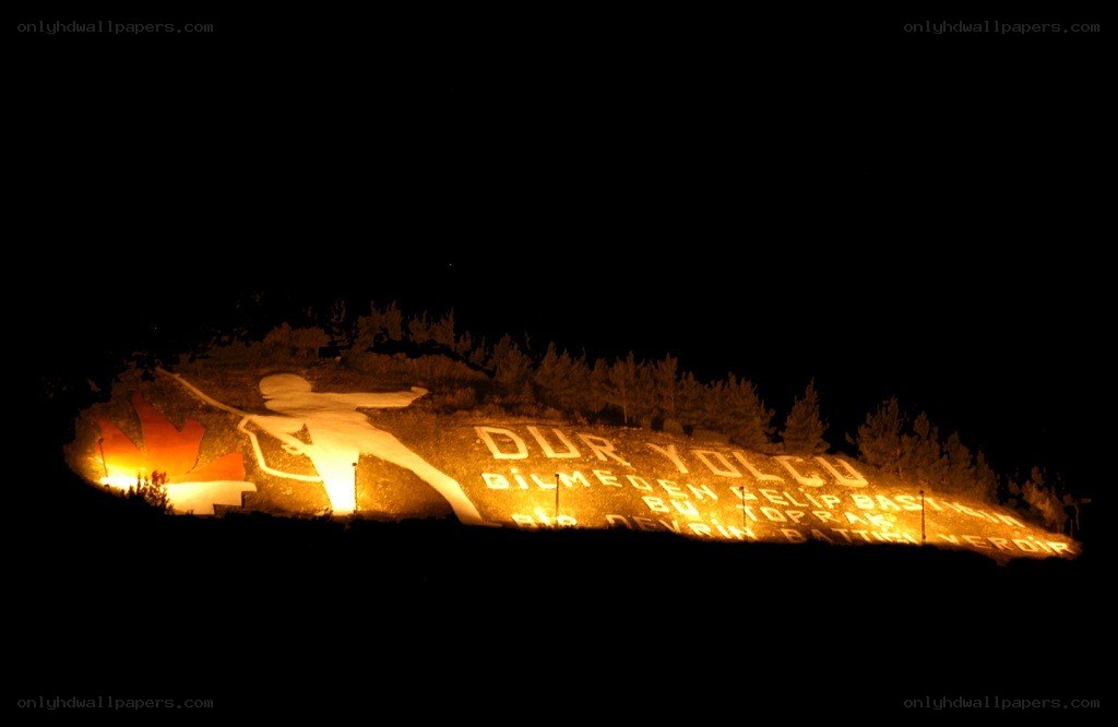 Illuminated hillside monument at night