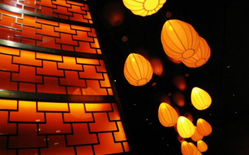 illuminated lanterns and brick wall