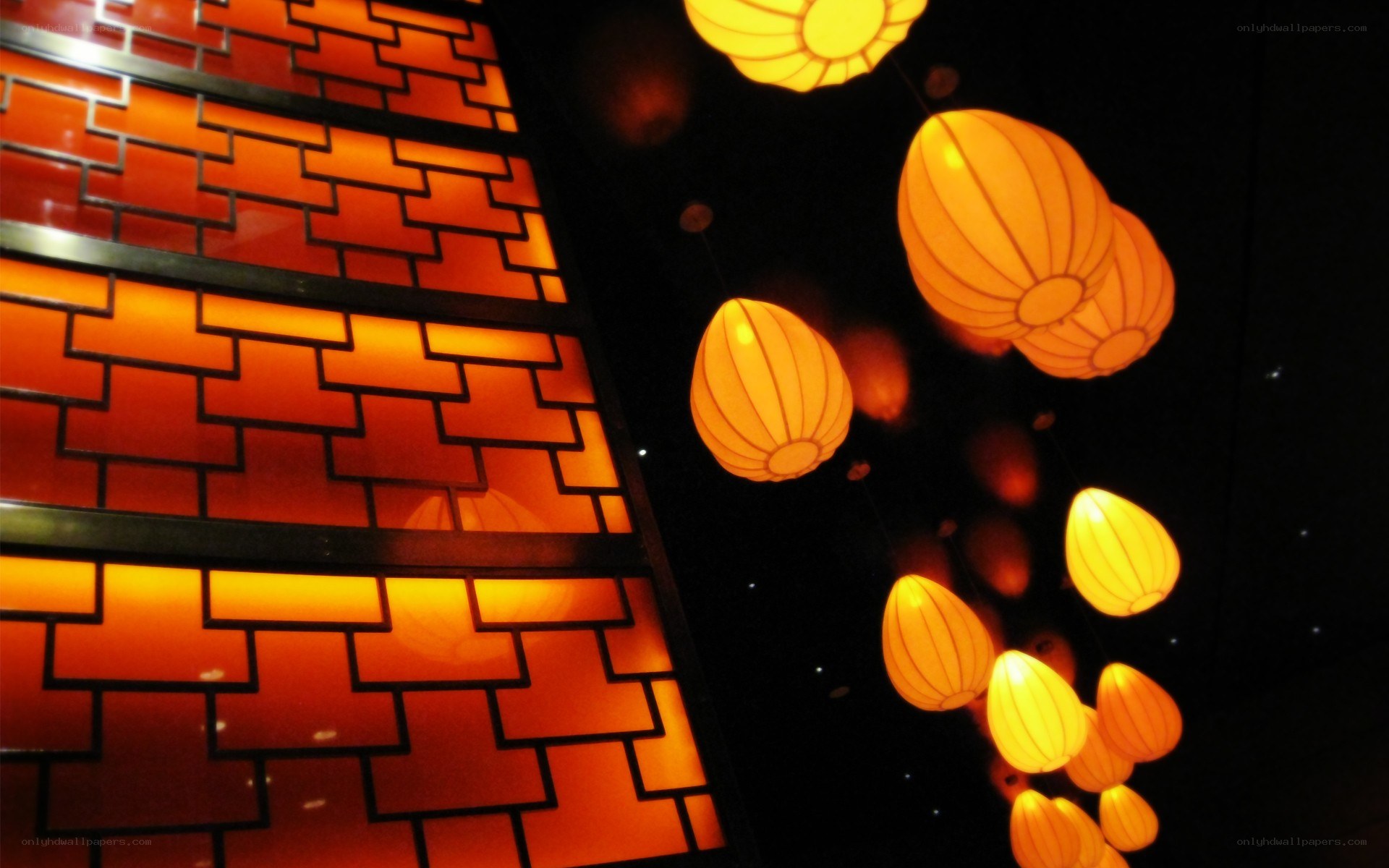 illuminated lanterns and brick wall