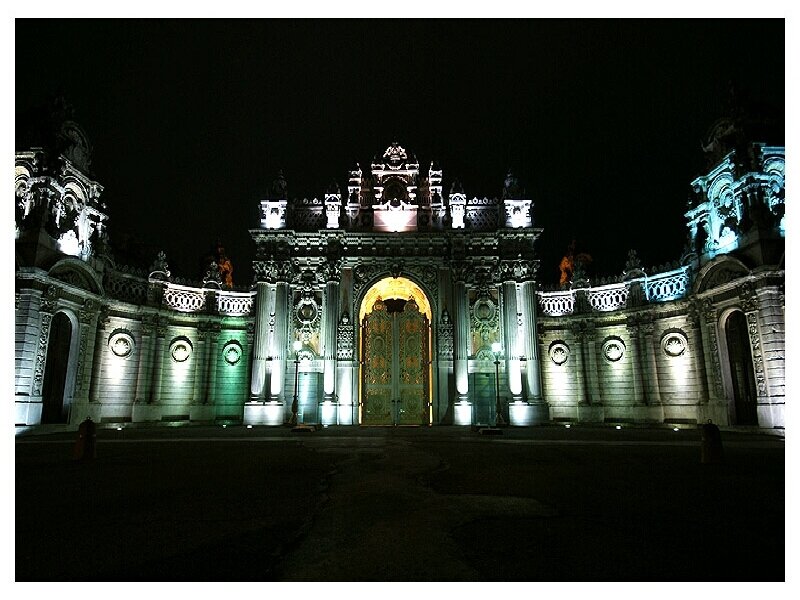 illuminated palace gate at night