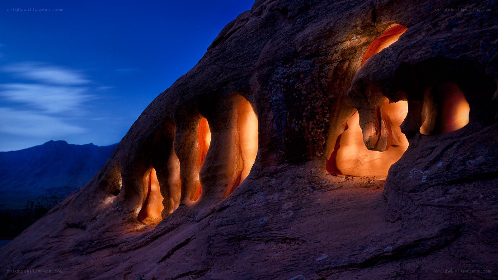 Illuminated rock formations at dusk