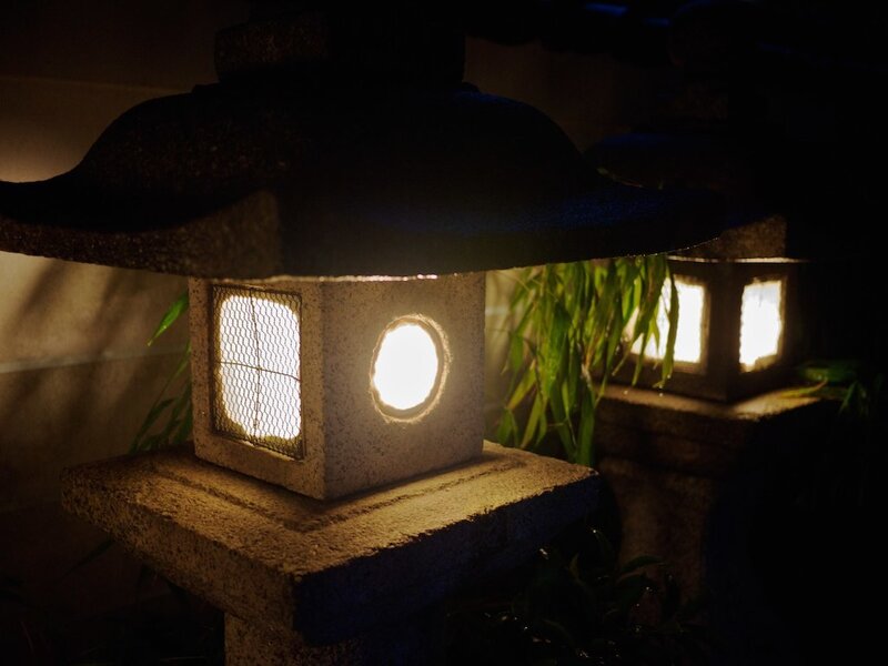 Illuminated stone lanterns at night