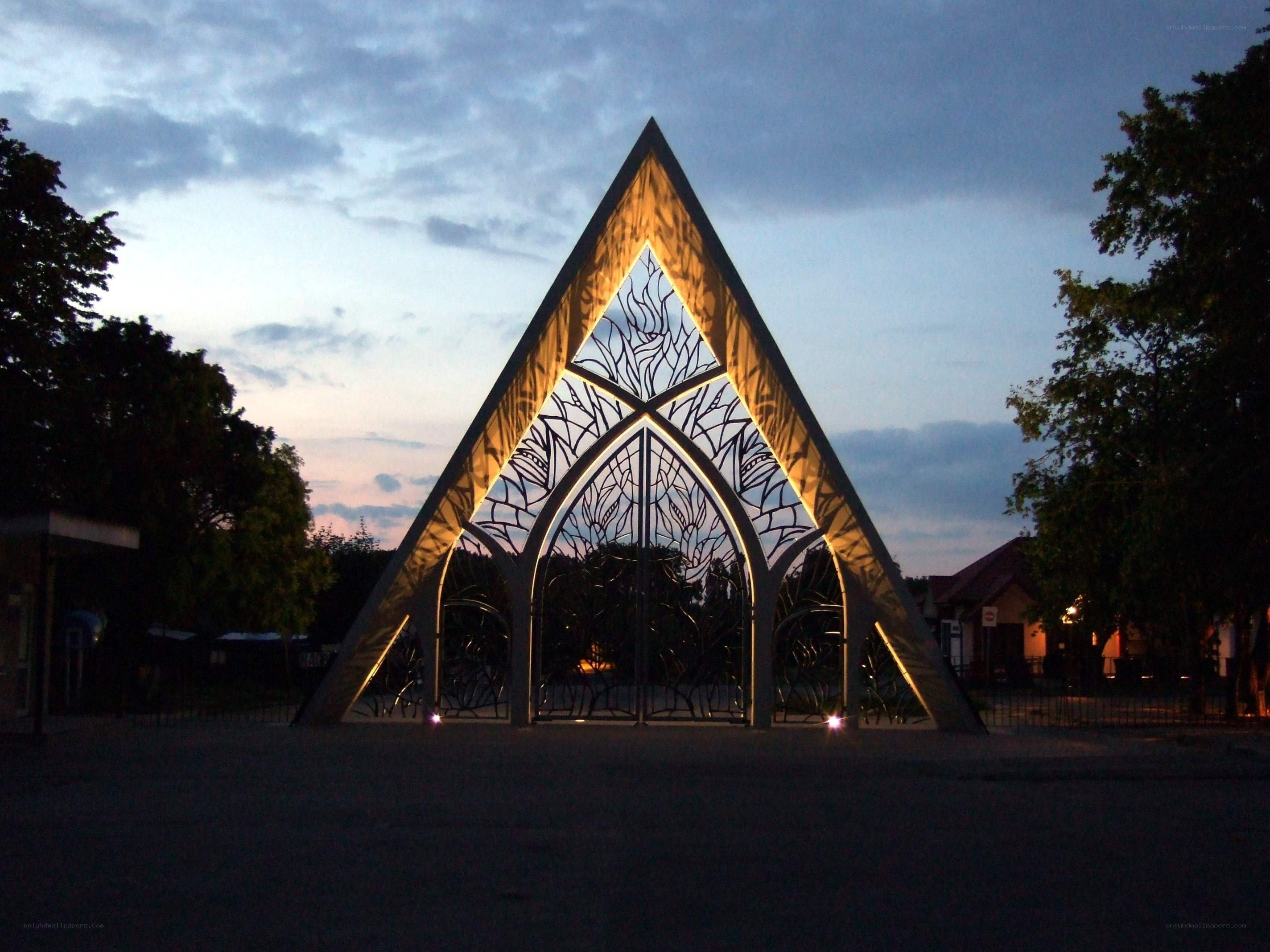 illuminated triangular gate at dusk