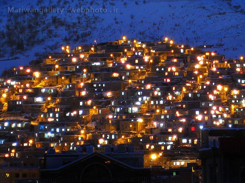 Illuminated village on a snowy hill
