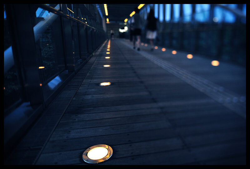 illuminated walkway at dusk
