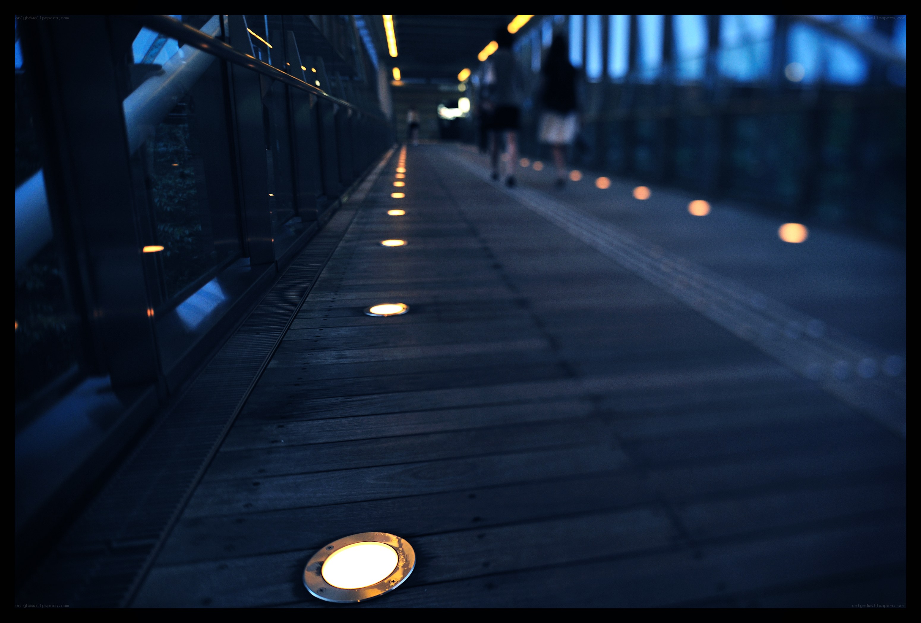 illuminated walkway at dusk