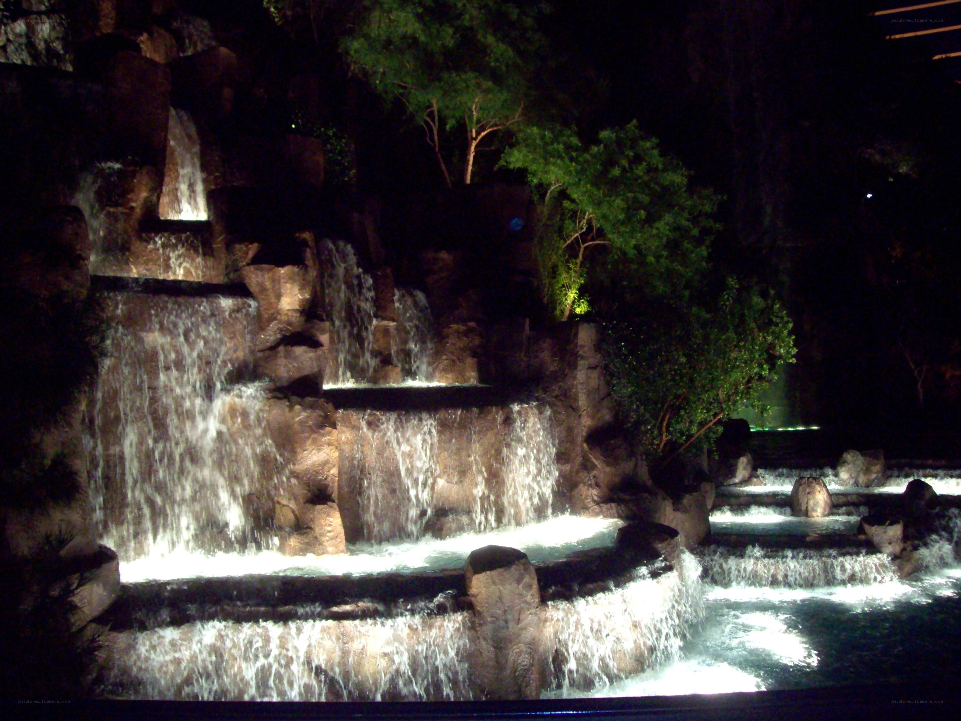 Illuminated waterfall at night