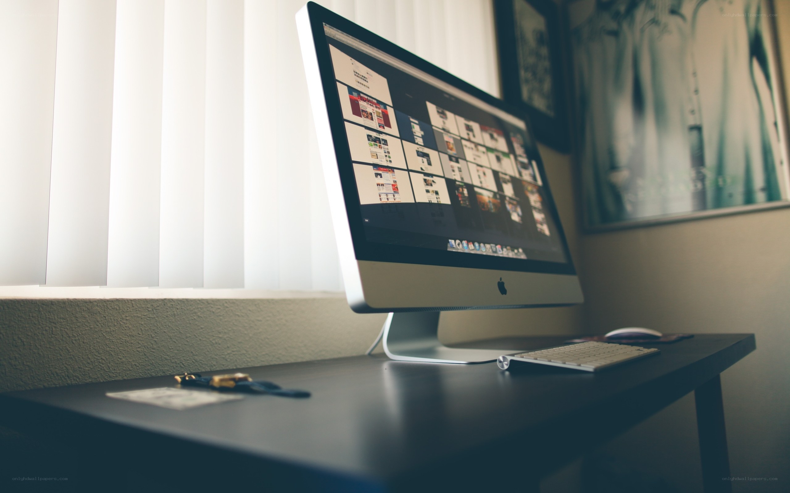 iMac on a desk by a window