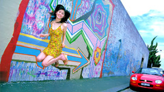 Asian girl jumping sidewalk