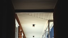 Blue red white ceiling Bricks down hall hallway
