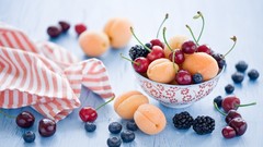Blueberries cherries fruits blackberries napkins bowls apricots