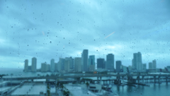 Cityscapes rain on glass