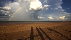 Coast rainbow clouds shadows