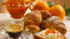 Coffee oranges bread croissants jam
