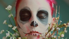 Dead woman faces Dia de Muertos