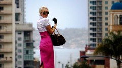 Gloves sunglasses blondes purses models blurred background 