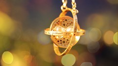 Gold pendant bokeh harry potter time travel