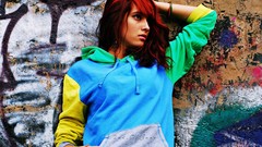 Graffiti woman multicolor sweatshirt redheads hands in pockets