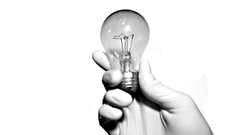 Hands grayscale light bulbs