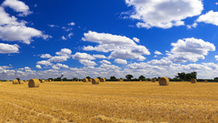 Hay bales blue clouds