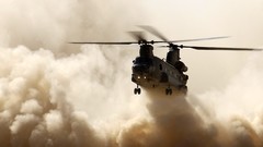 Helicopters smoke dust vehicles