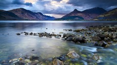 Landscapes Sea stones nature Mountains sky Dark Clouds