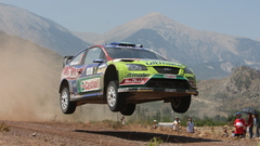 Mountains cars jumping dust