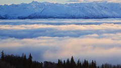 Mountains clouds bay Alaska below
