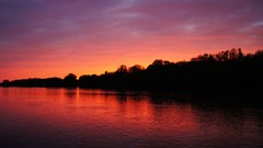 Night water sun clouds bright red light reflections multicolor 
