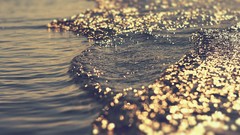 Sea water light glare waves bokeh tide