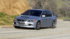 Silver cars Mitsubishi vehicles motion blur front angle view 