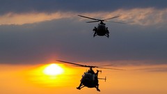 Sun clouds Aircraft Helicopters military flying landing pair 