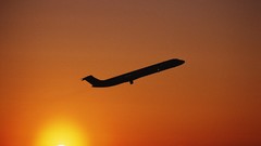 Sunrise dawn silhouettes take off planes MD-80